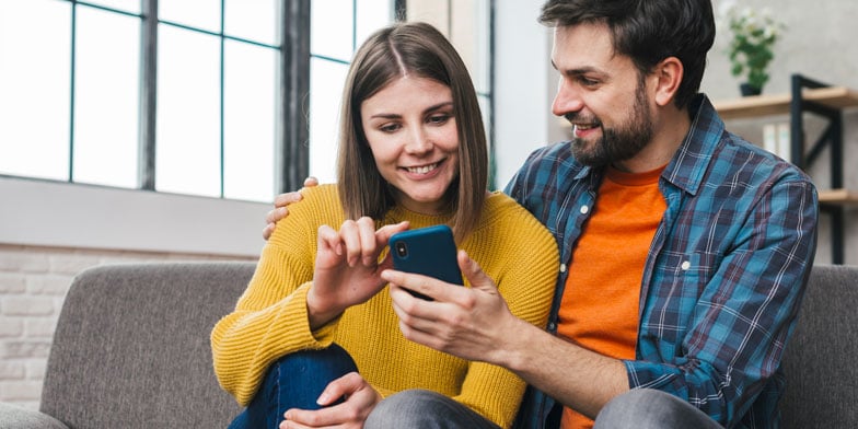 Couple playing online casino on a smartphone